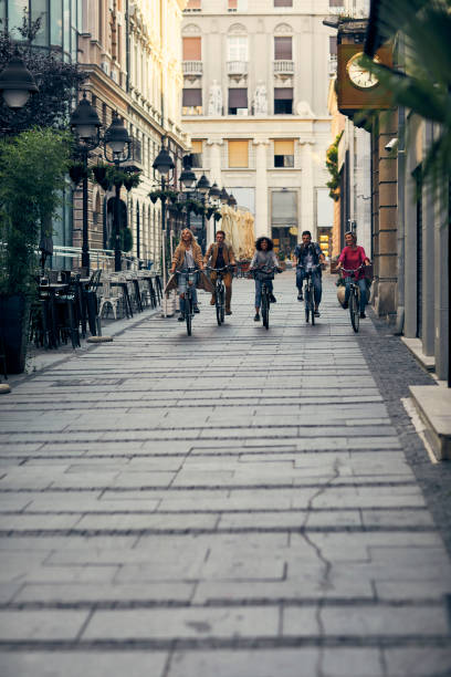 istock Friends Riding Bicycles In A City 1058881086