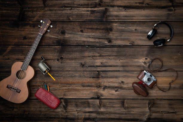 Text or logo empty copy space in vertical top view dark vintage wood.Retro sharpener,guitar ukulele,camera,headphones.Winter holiday season party social media card background