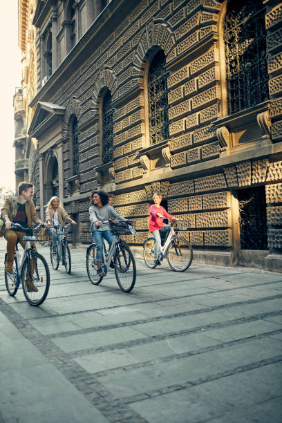 istock Friends Riding Bicycles In A City 1058881728