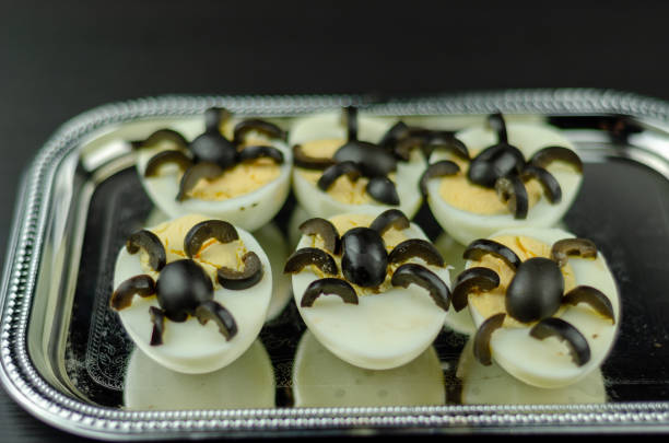 istock funny snack with olive spiders on egg halves for halloween party, 1058882364