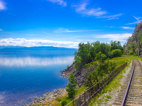 Bright summer landscape on the Circum-Baikal railway on the coast of Lake Baikal as a section of the Trans-Siberian Railway
