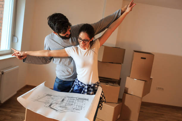 istock Young couple moving into a new house. 1058882646