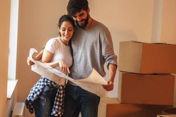 istock Young couple moving into a new house. 1058883072