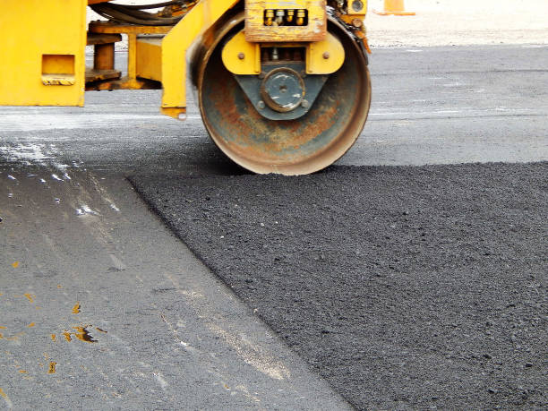 istock paver Road construction, asphalt concrete pavementpaver Road construction, asphalt concrete pavement during the sunny day 1058883884