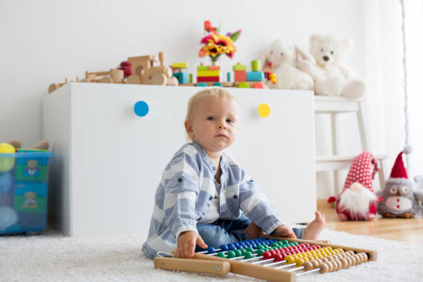istock Cute little baby boy, playing with abacus at home 1058885906