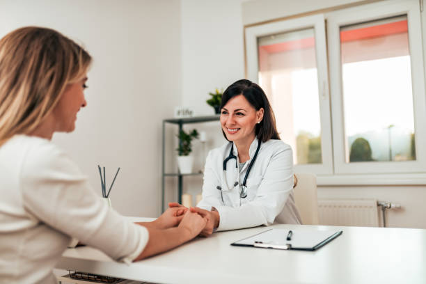 istock Friendly female doctor cheering and supporting patient. 1058886114