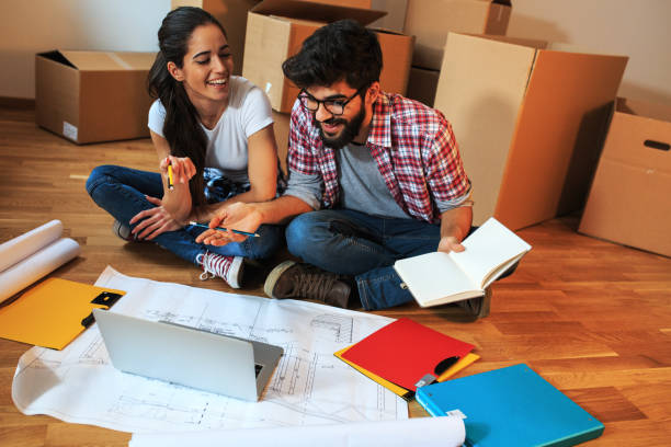 istock Young couple moving into a new house. 1058886230