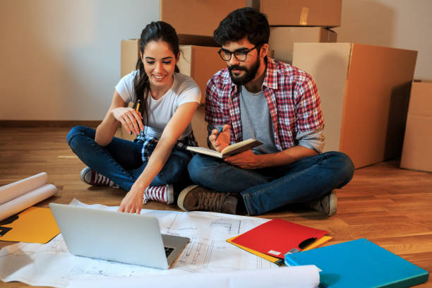 istock Young couple moving into a new house. 1058886232
