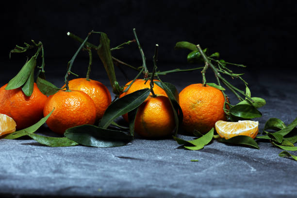 fresh ripe tangarines, food closeup on grey background.