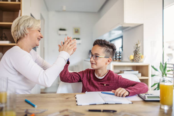 istock Mother Helping Adorable Son With Homework 1058889504
