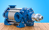 Horizontal multistage centrifugal pump on the wooden table, 3D rendering