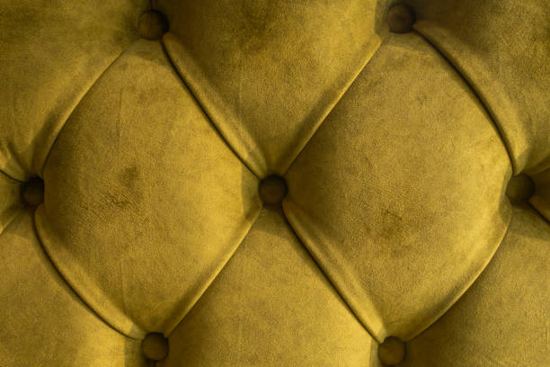 istock Green velvet capitone textile background, retro Chesterfield style checkered soft tufted fabric furniture diamond pattern decoration with buttons, close up. 1058890224