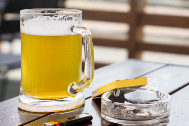 istock a beer at the table, a pack of cigarettes 1058891532