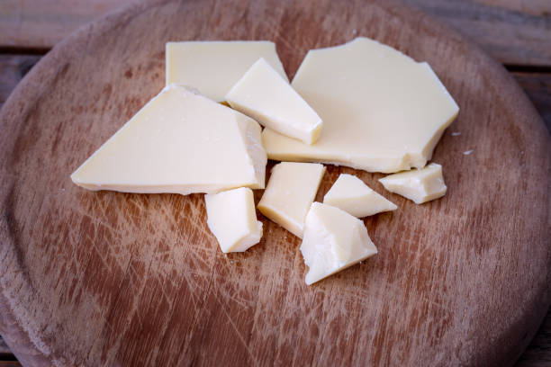istock White chocolate bar crushed at wood plate 1058907042