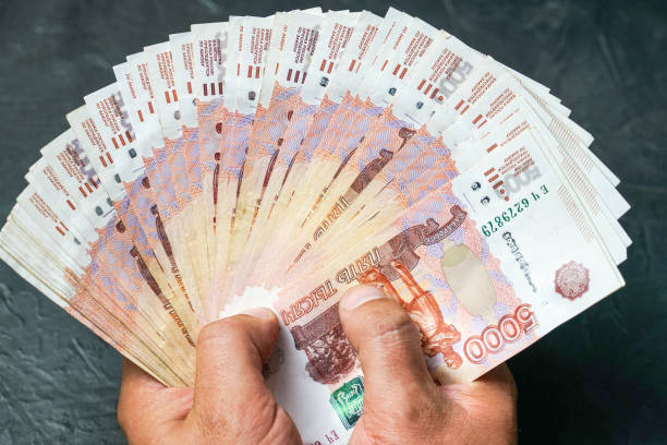 istock A man finds a banknote 5000 rubles. Place for your text. 1058907328
