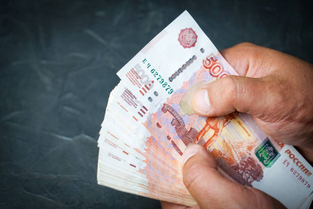 istock A man finds a banknote 5000 rubles. Place for your text. 1058907358