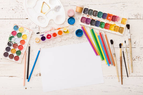 istock Top view on colorful paints and brushes. Creative ideas, creativity and early learning. Education concept. 1058907490