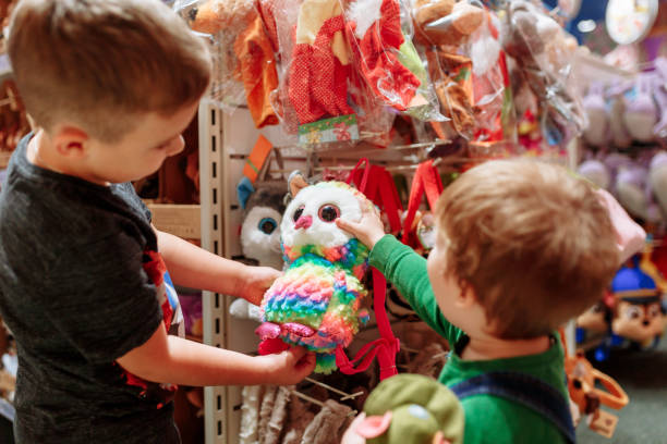 Two cute baby boys walking together in mall. Pair of kid friends holding hands during walk Two cute baby boys walking together in mall. Pair of kid friends holding hands during walk. toy store stock pictures, royalty-free photos & images