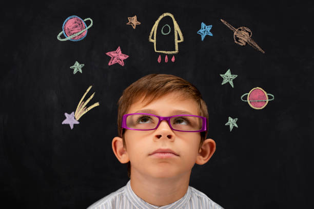istock Child imagines the cosmos with blackboard 1058907714