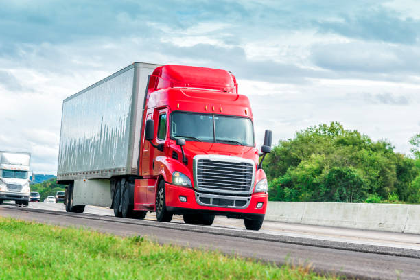 istock Red Eighteen Wheeler Travels Interstate Highway 1058907964