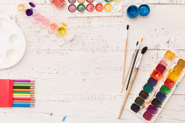 istock Top view on colorful paints and brushes. Creative ideas, creativity and early learning. Education concept. 1058909096