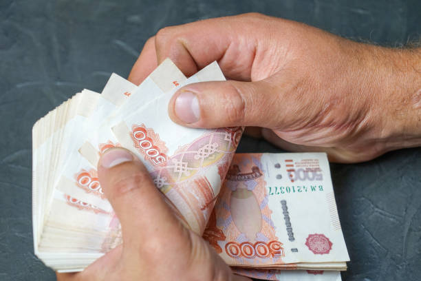 istock A man finds a banknote 5000 rubles. Place for your text. 1058909132
