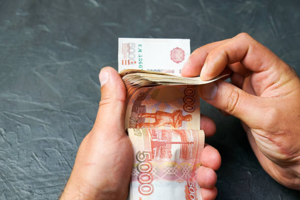 istock A man finds a banknote 5000 rubles. Place for your text. 1058909284