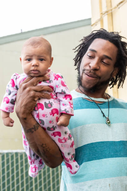 istock Black young man posing with his baby 1058910390