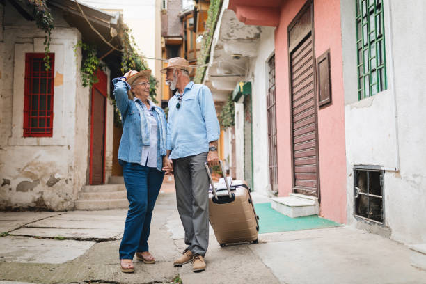 istock Lovely senior couple holding hands while traveling 1058911440