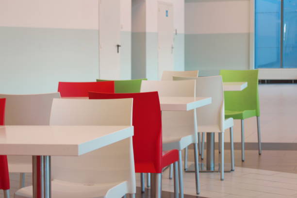 istock Chairs, tables doors to toilets in the cafeteria. 1058912122