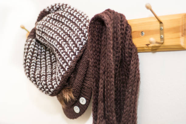 istock Woolen hat and scarf hang out on hat stand 1058917430