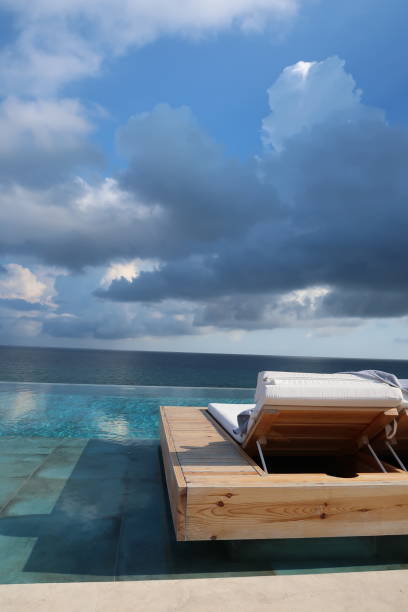 istock pool lounger cloudy view to ocean (open left ) 1058919278
