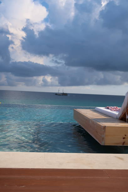 istock pool lounger cloudy view to ocean (open left ) 1058919318