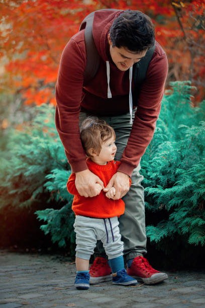 istock Young father with a child have a fun in a park. 1058923016