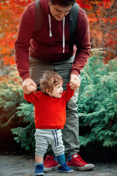 istock Young father with a child have a fun in a park. 1058923022