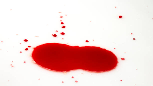 istock drops of red blood on white paper 1058924198