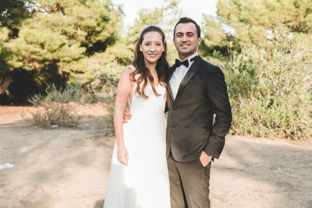 istock Bride and grrom holding hands  looking to camera 1058929904
