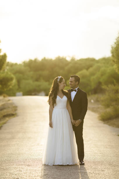 istock Bride and grrom holding hands  looking to each other 1058930558