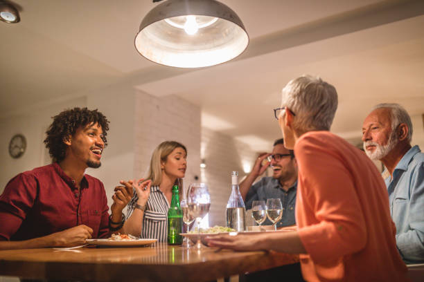 istock Lovely friends and family telling stories while dining 1058935508