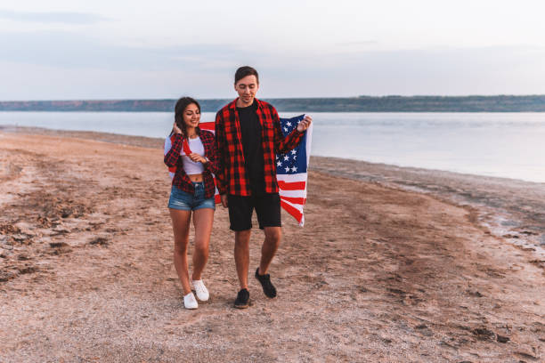 istock oung couple on the beach walking together 1058937376
