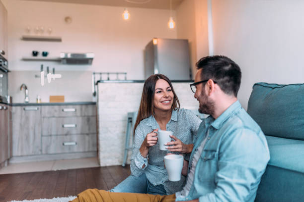 istock Happy couple talking and drinking coffee. 1058939930