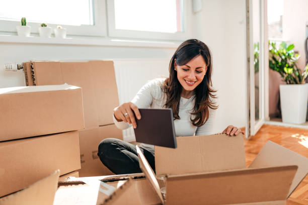 istock Lovely brunette unpacking at her new apartment. 1058940896