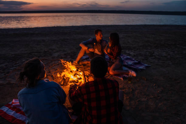 istock young friends have picnic with bonfire on the beach 1058941872