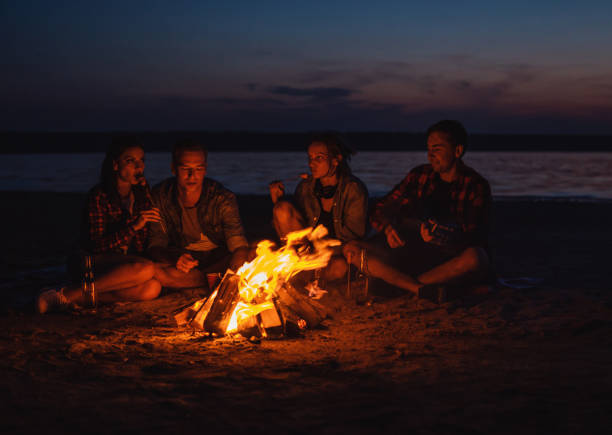 istock young friends have picnic with bonfire on the beach 1058943032