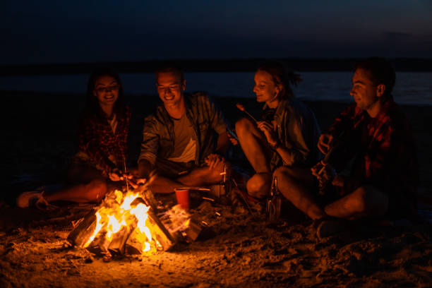 istock young friends have picnic with bonfire on the beach 1058944122
