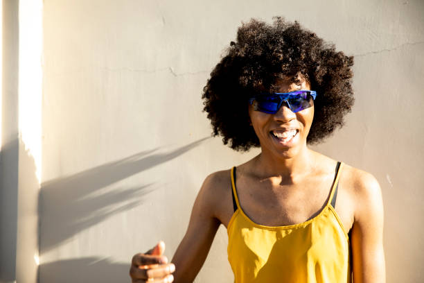 istock Young Black Woman Standing in Sunlight 1058944844