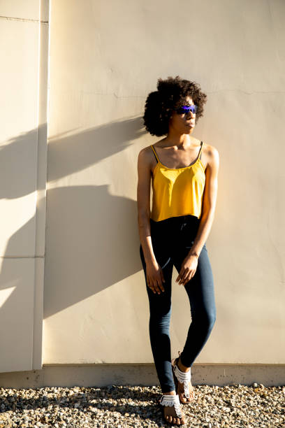 istock Young Black Woman Standing in Sunlight 1058944948