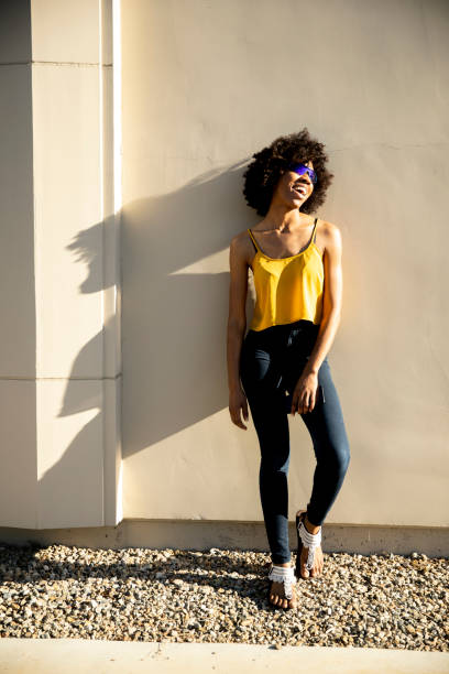istock Young Black Woman Standing in Sunlight 1058944974