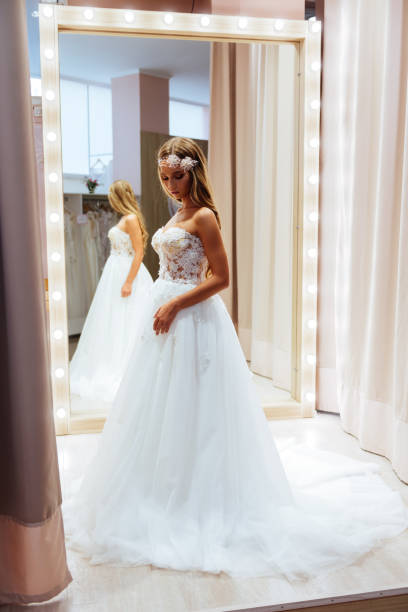 istock Beautiful bride is trying on an elegant wedding dress 1058951872