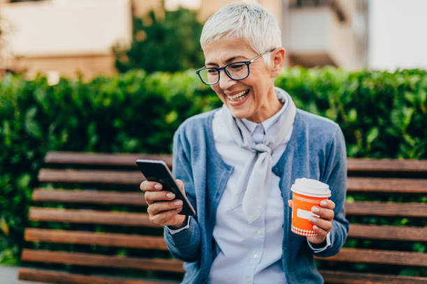 istock Senior woman usigg her smartphone 1058952556